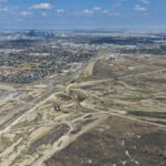 Earthworks and bridge construction for the future system interchange at Highway 8 / Sarcee Trail / Glenmore Trail (looking east)