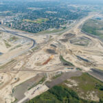 Bridge construction, earthworks and utility installations sharing space at the Sarcee Trail interchange (looking northeast)