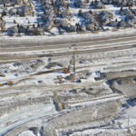 Driving piling for the east abutment of the new pedestrian bridge providing access between Woodbine and the Tsuut'ina Nation (looking east)
