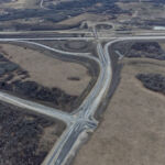 The intersection of Southland Drive and 90 Avenue is largely complete, with asphalt, curbs and drainage in place (looking southwest)
